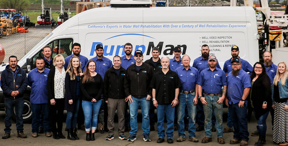 group of employees from PumpMan posing in front of service van